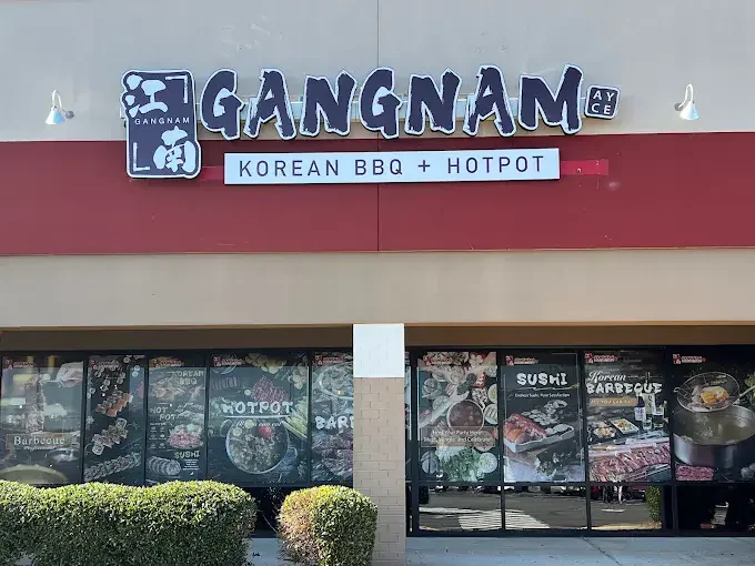 Gangnam Korean BBQ and Hotpot restaurant exterior storefront with blue signage and menu window displays